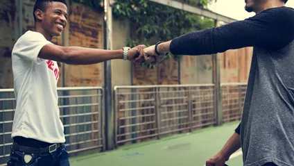 Two Guys Fist Bumping