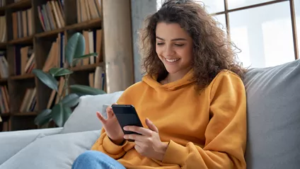 Young Woman Sat On The Sofa