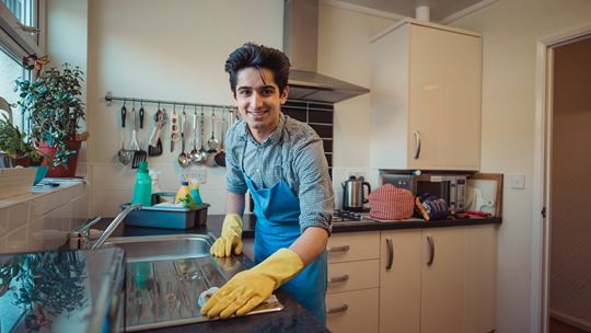 Young Man Cleaning The Kitchen